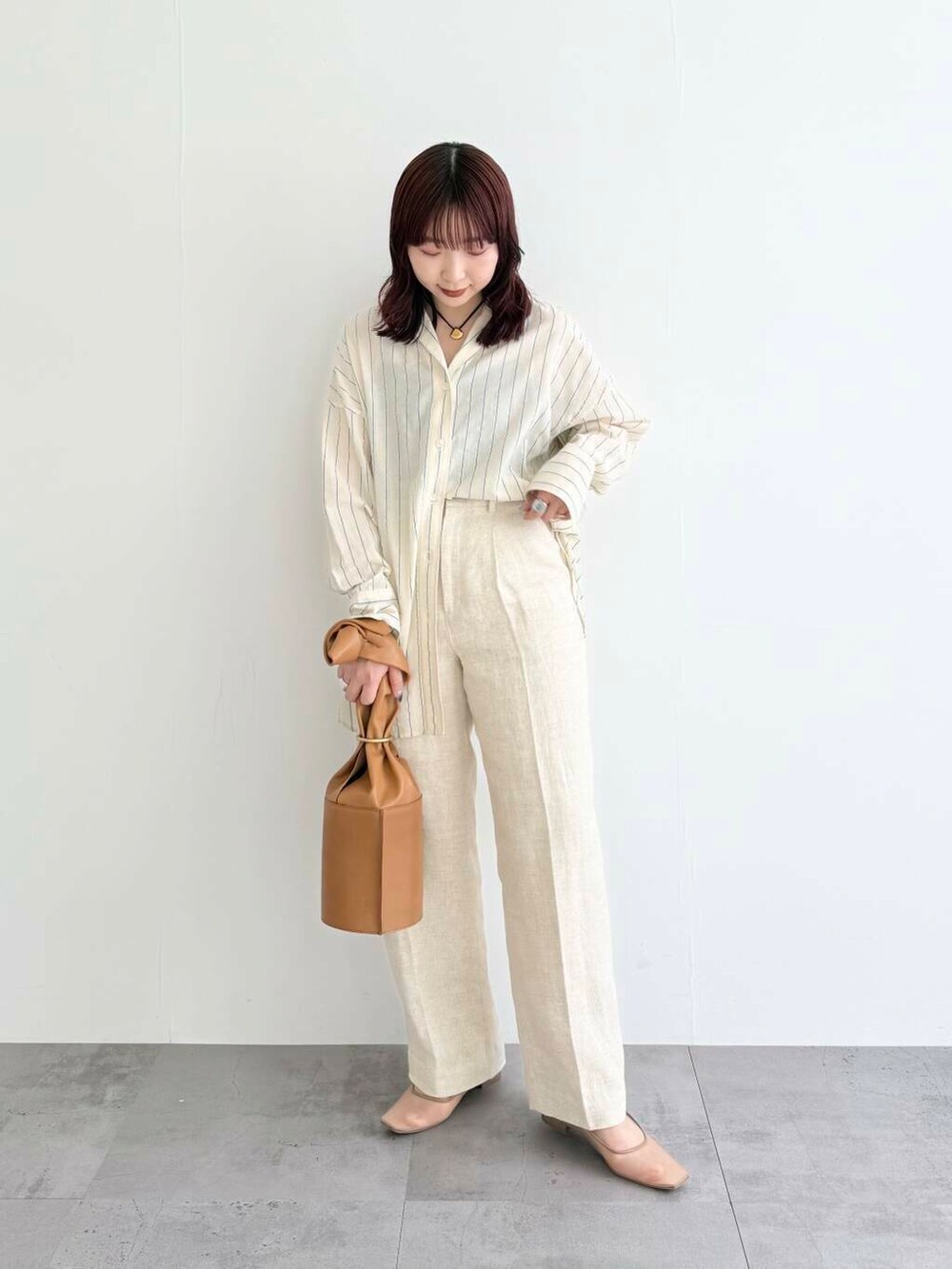 ベージュ系のその他パンツ、ベージュ系のパンプス、ベージュ系のシャツ/ブラウスを着用したレディースの春コーディネートの2枚目の写真