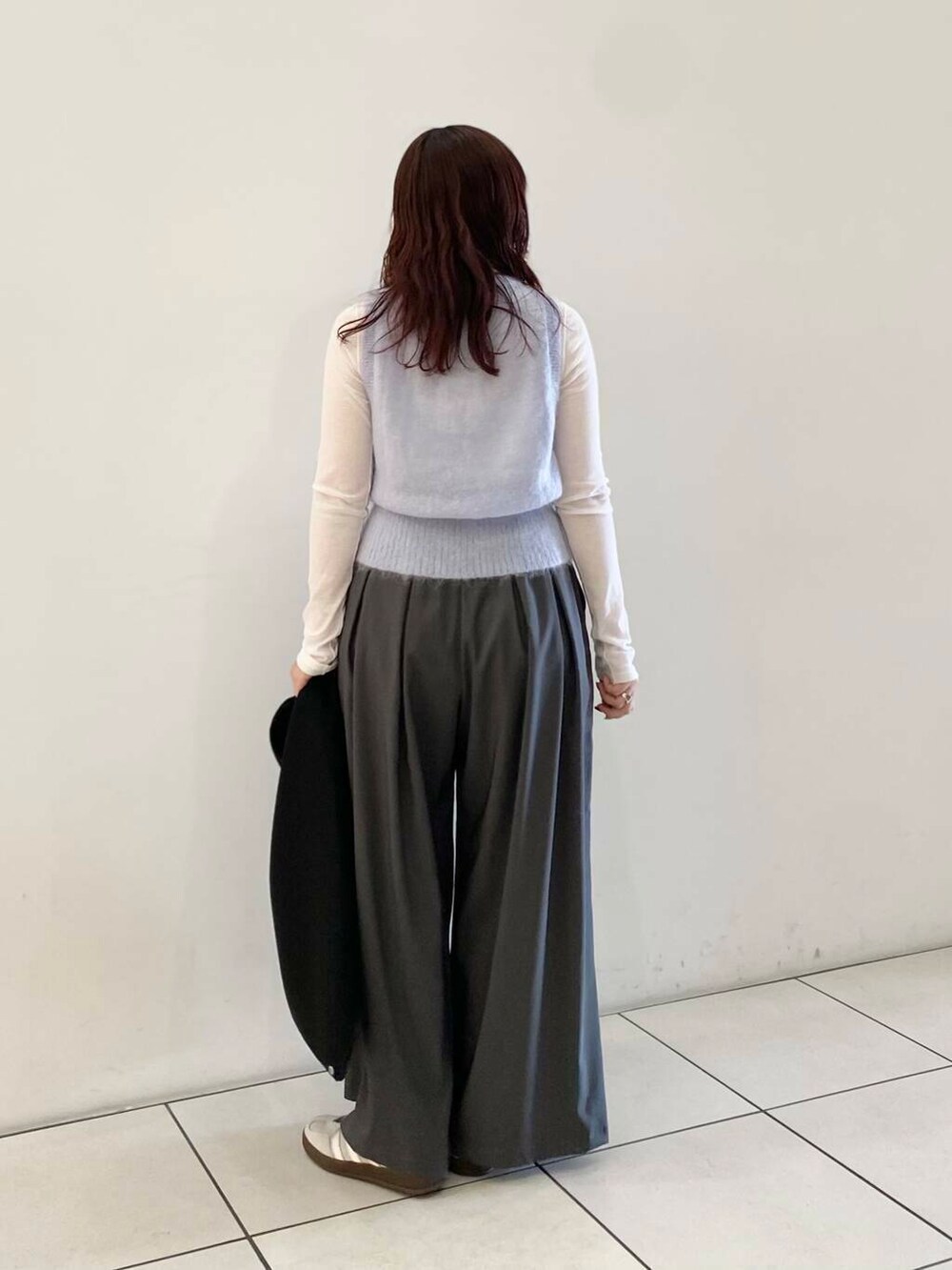 ホワイト系のTシャツ/カットソー、グレー系のベスト、グレー系のその他パンツを着用したレディースの秋コーディネートの3枚目の写真