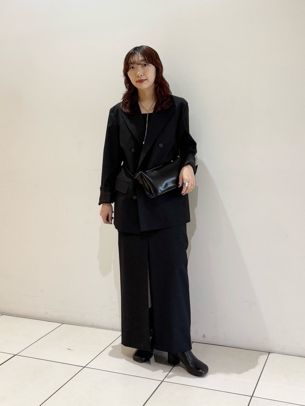 ブラック系のボディバッグ/ウエストポーチ、ブラック系のその他アウター、ブラック系のスカートを着用したレディースの秋コーディネートの2枚目の写真