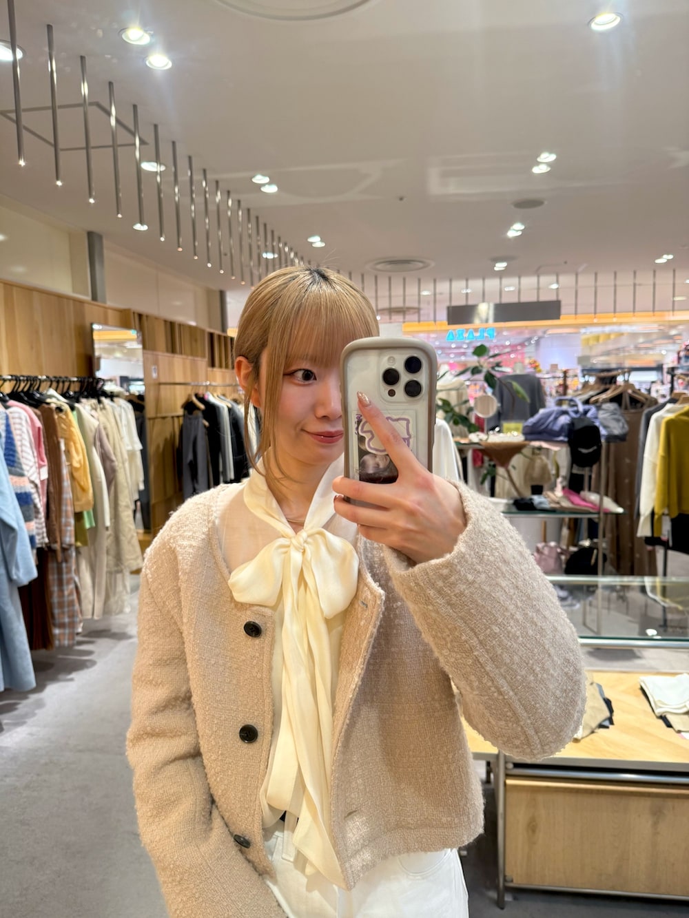 ブラウン系のブーツ、ホワイト系のデニムパンツ、ホワイト系のシャツ/ブラウスを着用したレディースの冬コーディネートの2枚目の写真