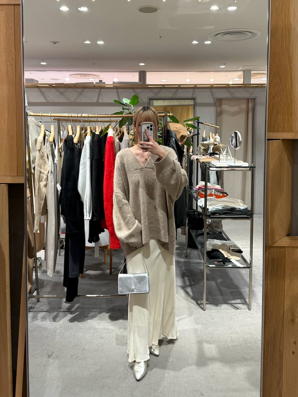 ベージュ系のニット/セーター、ホワイト系のスカートを着用したレディースの冬コーディネートの4枚目の写真