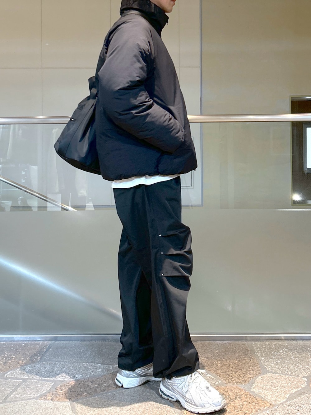 ブラック系のダウンジャケット/コート、ブラック系のその他パンツを着用したメンズの冬コーディネートの2枚目の写真