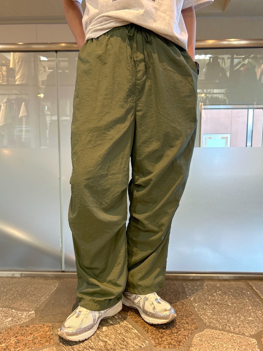 グレー系のTシャツ/カットソー、グリーン系のカーゴパンツを着用したメンズの夏コーディネートの4枚目の写真