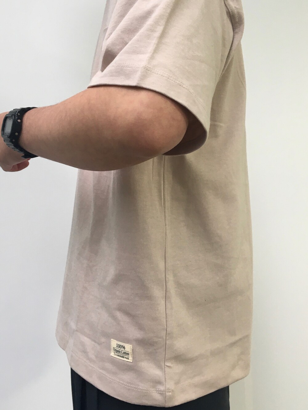 ベージュ系のTシャツ/カットソー、ブラック系のスラックスを着用したメンズの春コーディネートの5枚目の写真