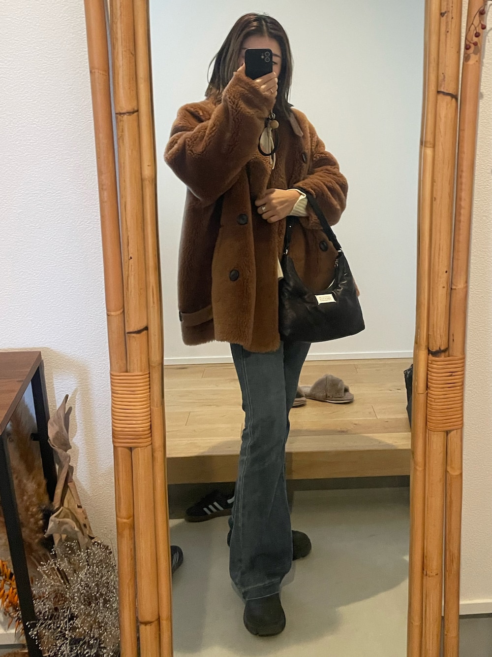 ブラウン系のジャケット/アウター、ブラック系のショルダーバッグ、ブラック系のブーツを着用したレディースの冬コーディネートの2枚目の写真