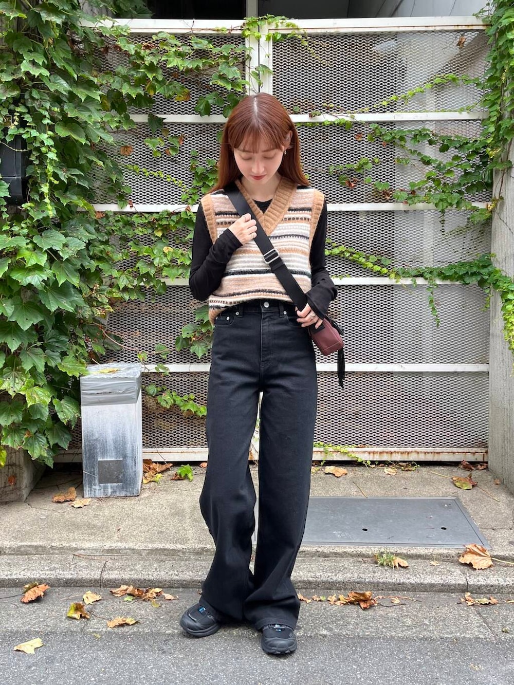 ブラック系のTシャツ/カットソー、ブラック系のスニーカー、ブラウン系のベストを着用したレディースの夏コーディネートの3枚目の写真