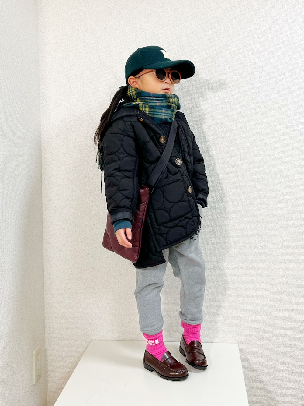 ブラック系のダウンジャケット/コート、グレー系のスウェットパンツ、ブラック系のニット/セーターを着用したキッズの冬コーディネートの2枚目の写真