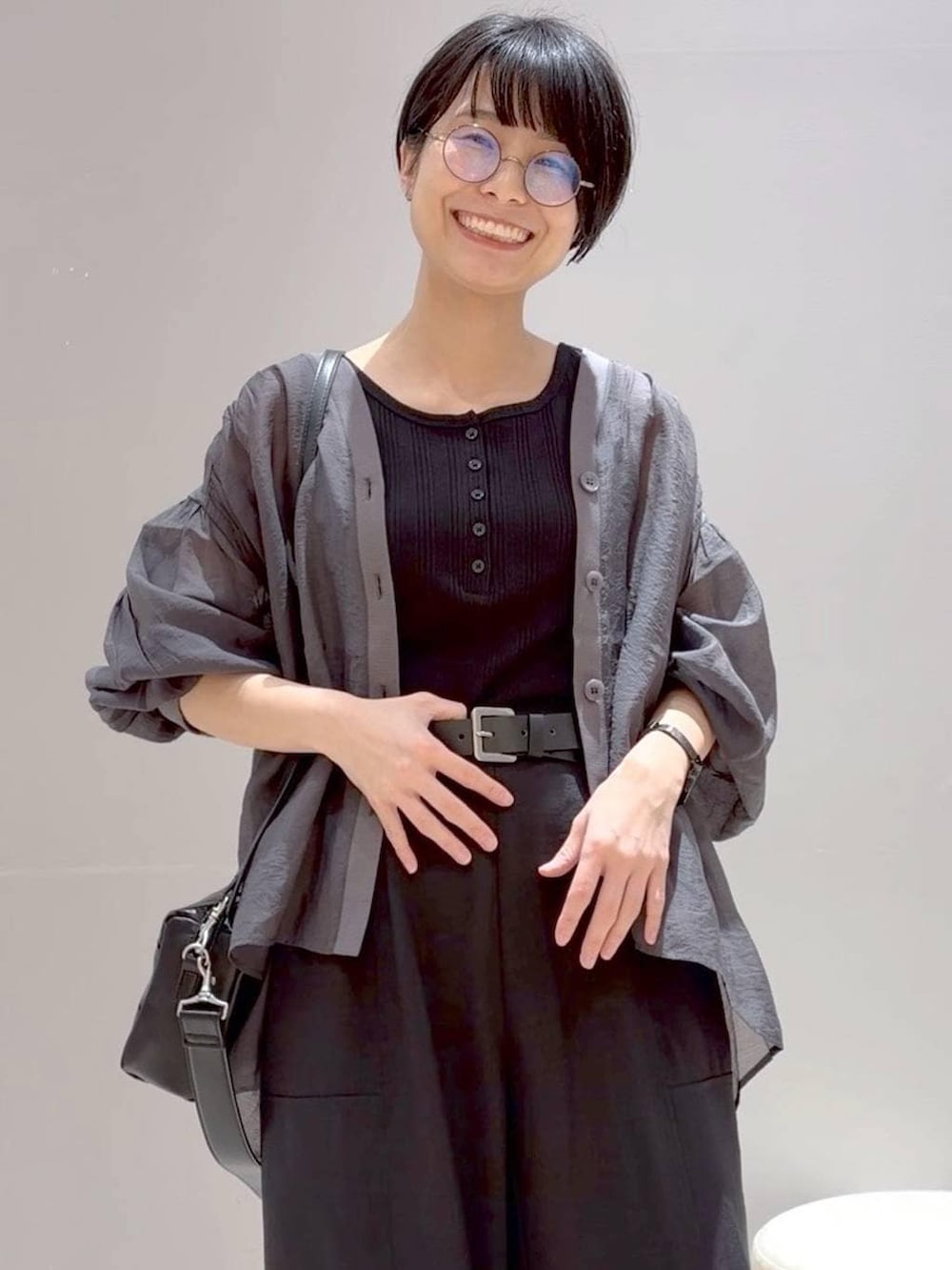 ブラック系のその他パンツ、グレー系のシャツ/ブラウス、ブラック系のショルダーバッグを着用したレディースの春コーディネートの3枚目の写真