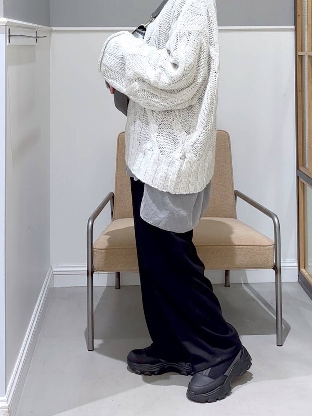 グレー系のショルダーバッグ、ブラック系のその他パンツ、グレー系のニット/セーターを着用したレディースの秋コーディネートの3枚目の写真