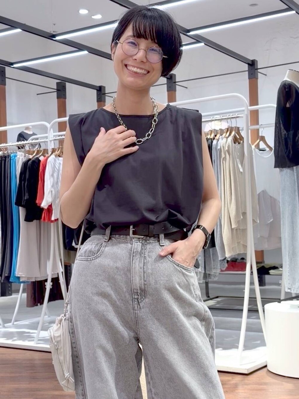ブラック系のTシャツ/カットソー、ブラック系のサンダル、ホワイト系のショルダーバッグを着用したレディースの夏コーディネートの5枚目の写真