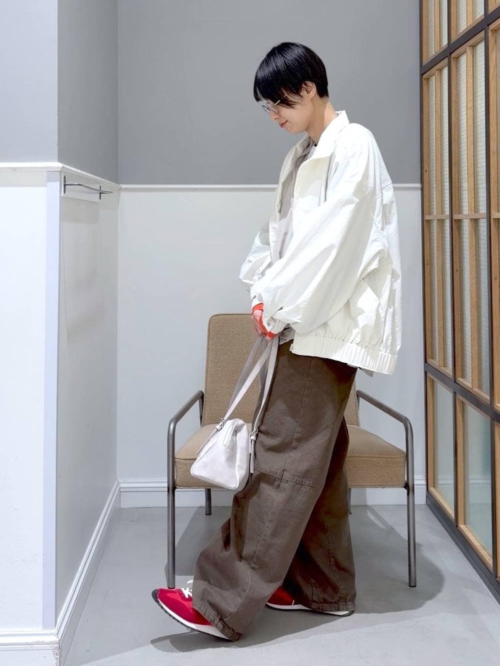 グレー系のボストンバッグ、ホワイト系のTシャツ/カットソー、グリーン系のその他パンツを着用したレディースの冬コーディネートの5枚目の写真