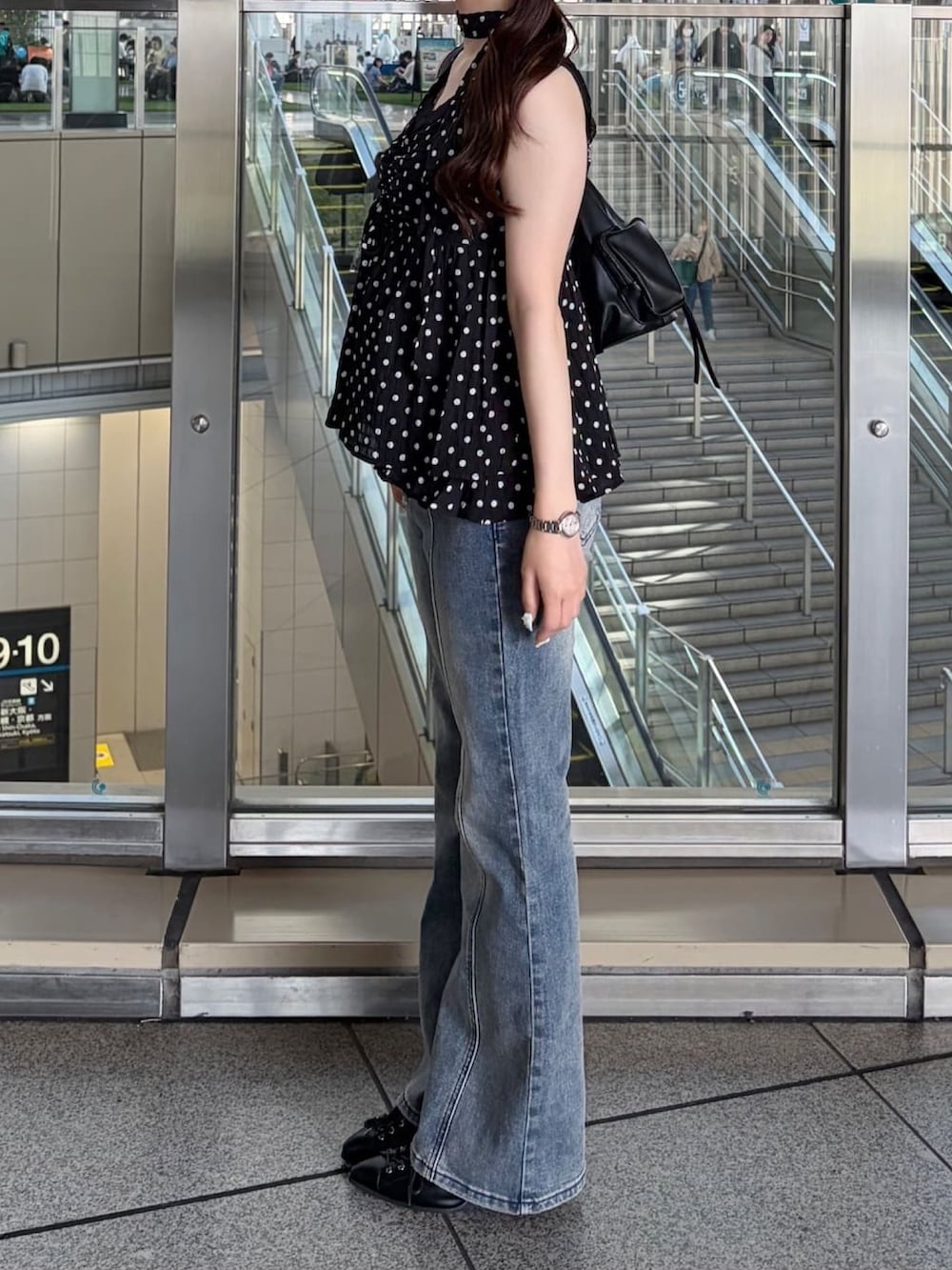 ブラック系のシャツ/ブラウス、ブルー系のデニムパンツを着用したレディースの春コーディネートの3枚目の写真