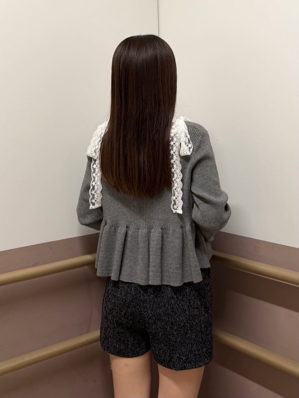 グレー系のアンサンブル、ホワイト系のショルダーバッグ、ブラック系のその他パンツを着用したレディースの秋コーディネートの3枚目の写真