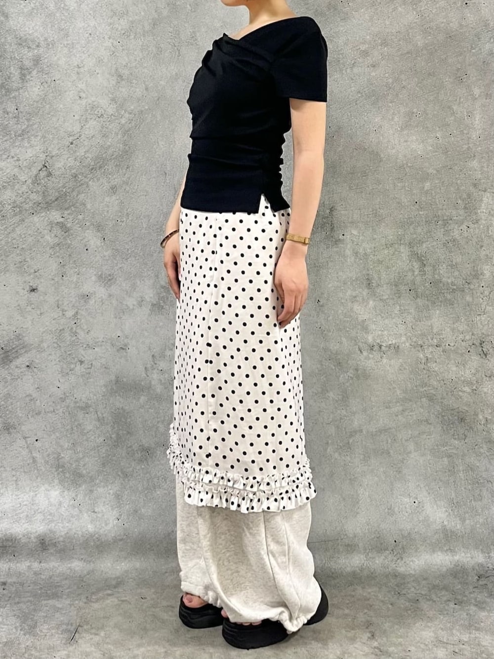 ホワイト系のスカート、ブラック系のTシャツ/カットソー、ベージュ系のスウェットパンツを着用したレディースの夏コーディネートの2枚目の写真
