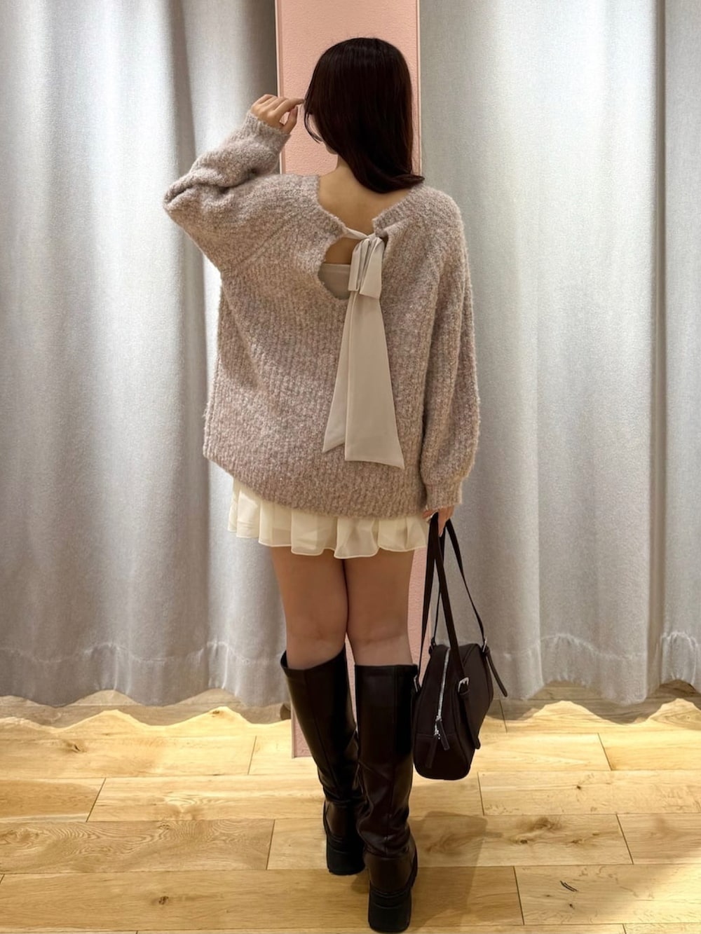 ピンク系のニット/セーター、ホワイト系のスカートを着用したレディースの秋コーディネートの3枚目の写真