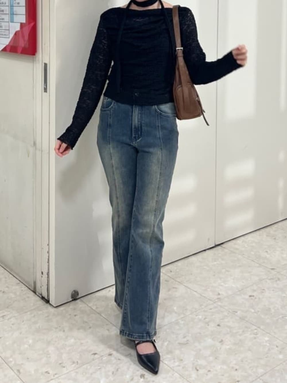 ブラック系のTシャツ/カットソー、ブルー系のデニムパンツ、ブラウン系のハンドバッグを着用したレディースの夏コーディネートの2枚目の写真