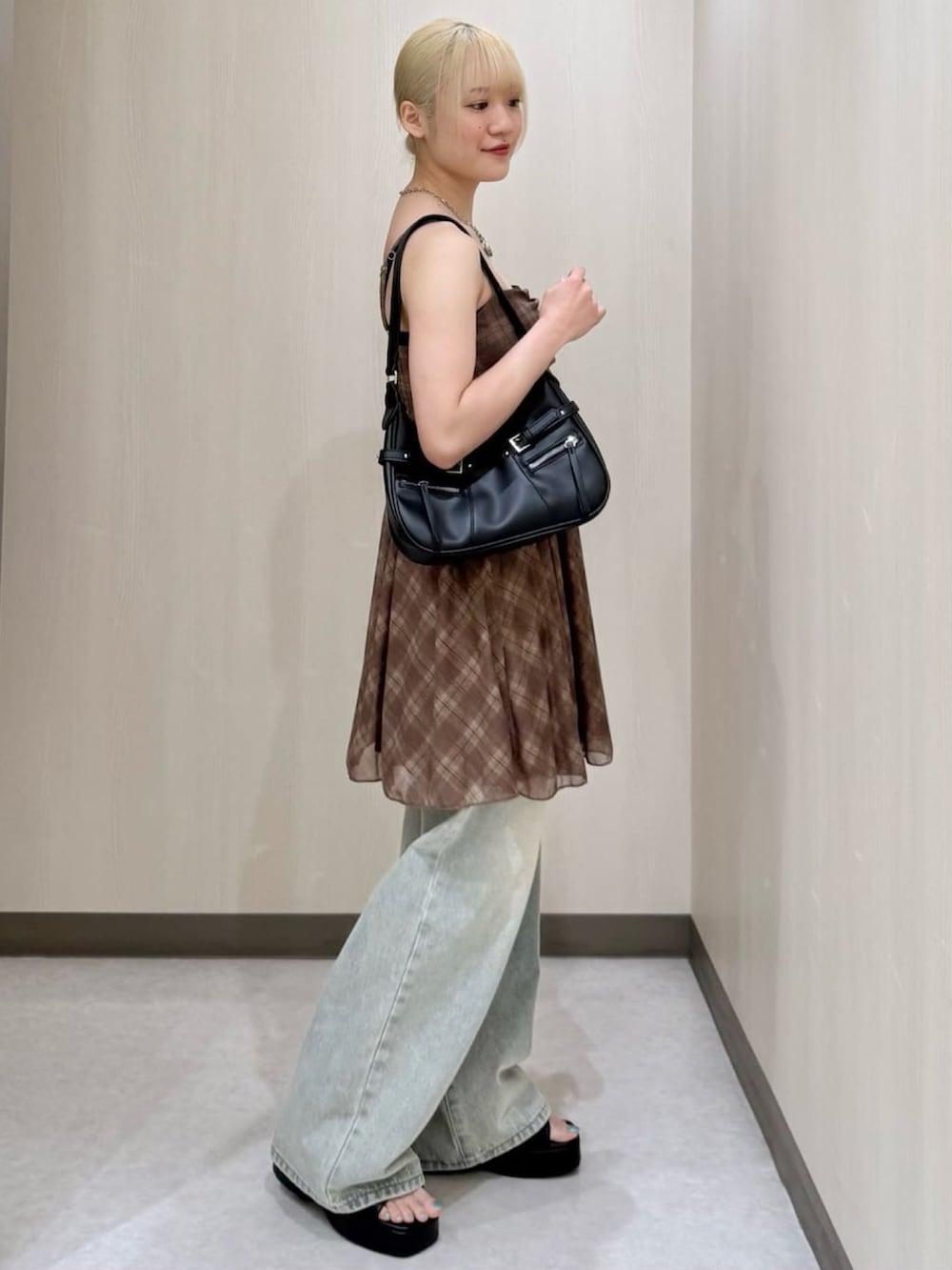 ブラウン系のワンピースを着用したレディースの夏コーディネートの2枚目の写真