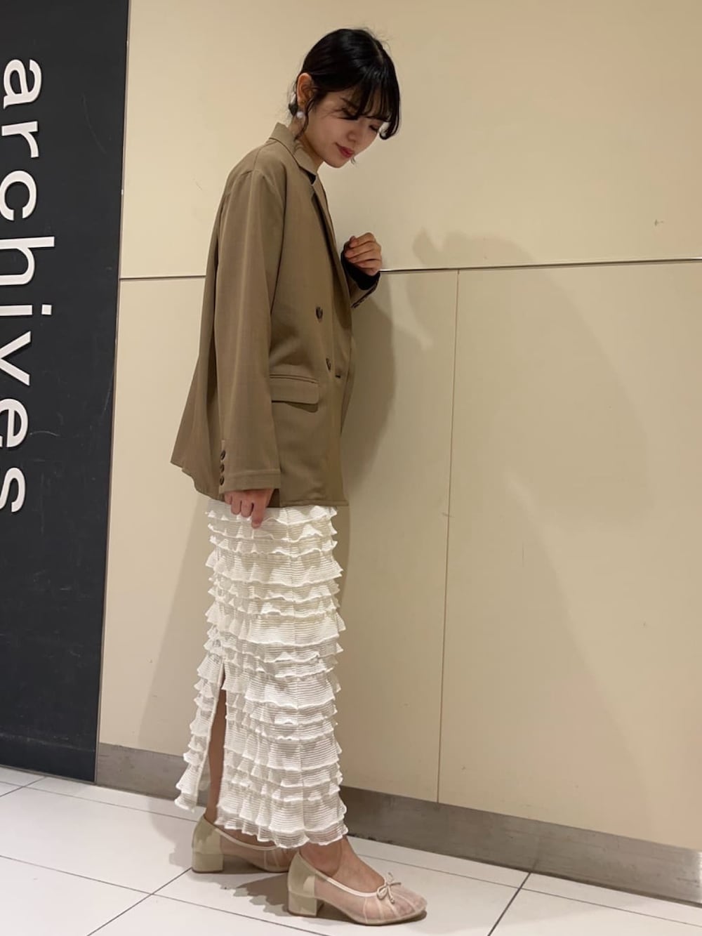 ブルー系のカーディガン/ボレロ、ブラウン系のテーラードジャケット、ホワイト系のスカートを着用したレディースの春コーディネートの2枚目の写真