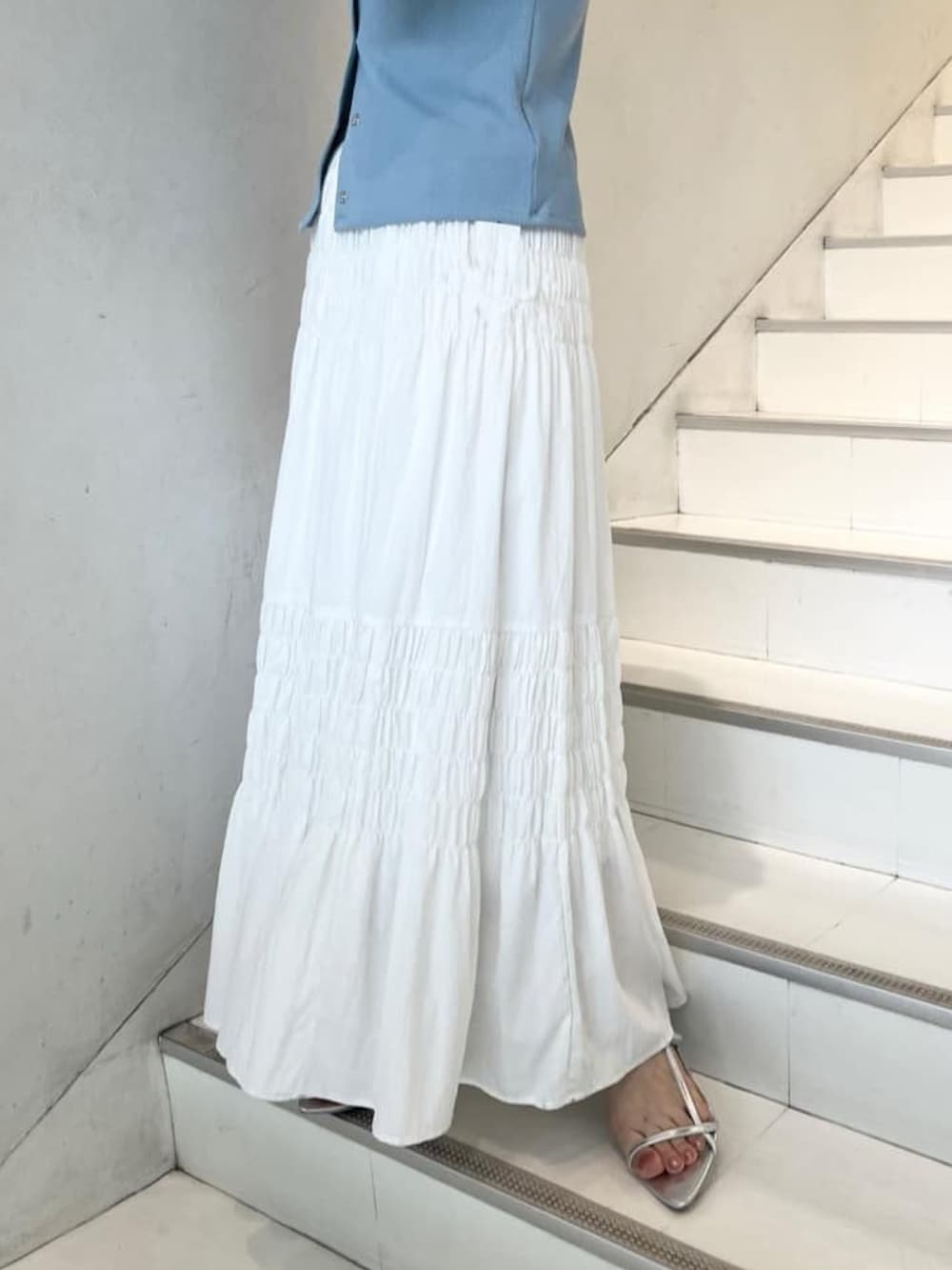 ブルー系のTシャツ/カットソー、ホワイト系のスカートを着用したレディースの夏コーディネートの2枚目の写真