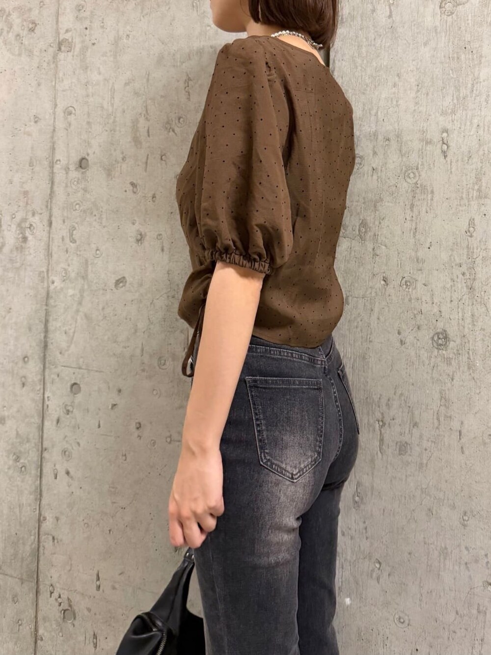 ブラウン系のシャツ/ブラウス、グレー系のデニムパンツ、ブラック系のショルダーバッグを着用したレディースの夏コーディネートの2枚目の写真
