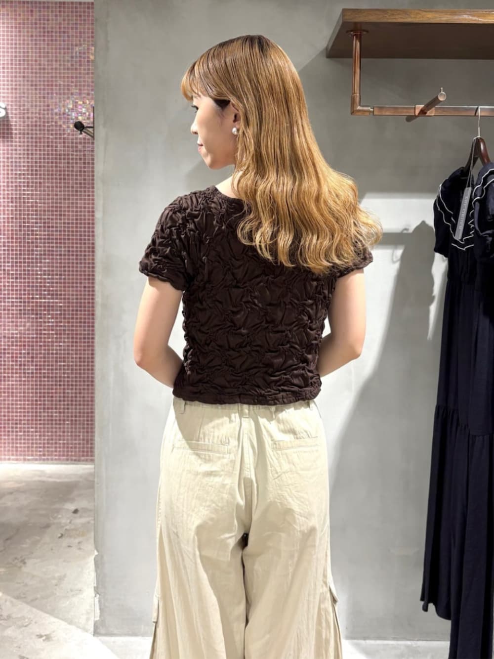 ブラック系のボストンバッグ、グレー系のサンダル、ブラウン系のTシャツ/カットソーを着用したレディースの夏コーディネートの3枚目の写真