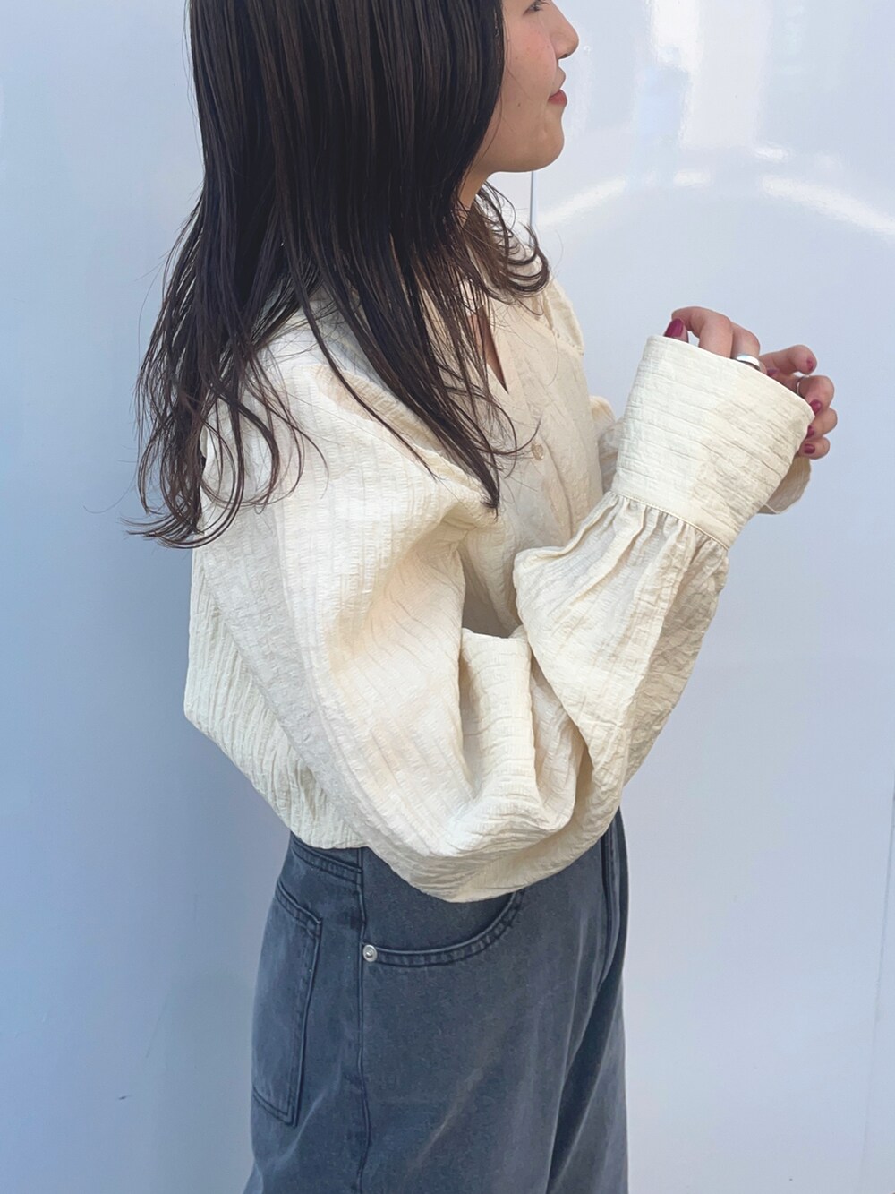 ブラック系のデニムパンツ、ホワイト系のシャツ/ブラウス、ブラック系のサンダルを着用したレディースの冬コーディネートの3枚目の写真