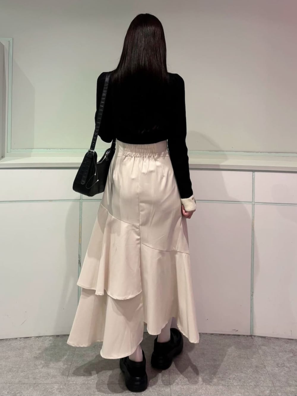 ホワイト系のスカート、ブラック系のニット/セーターを着用したレディースの秋コーディネートの3枚目の写真