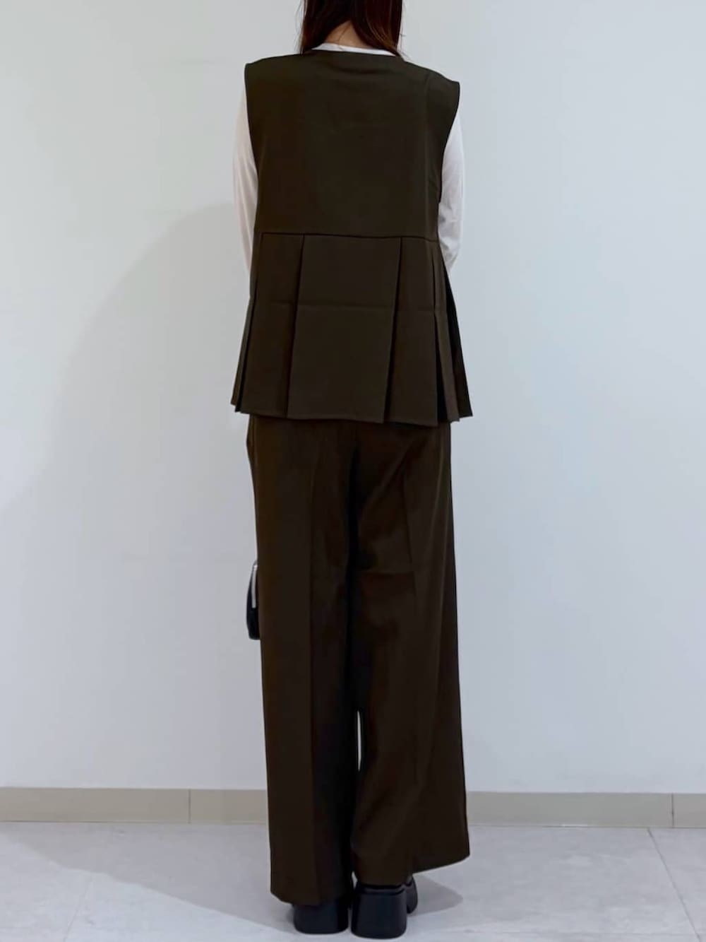 ブラウン系のその他パンツ、ブラック系のパンプス、ブラウン系のシャツ/ブラウスを着用したレディースの秋コーディネートの3枚目の写真