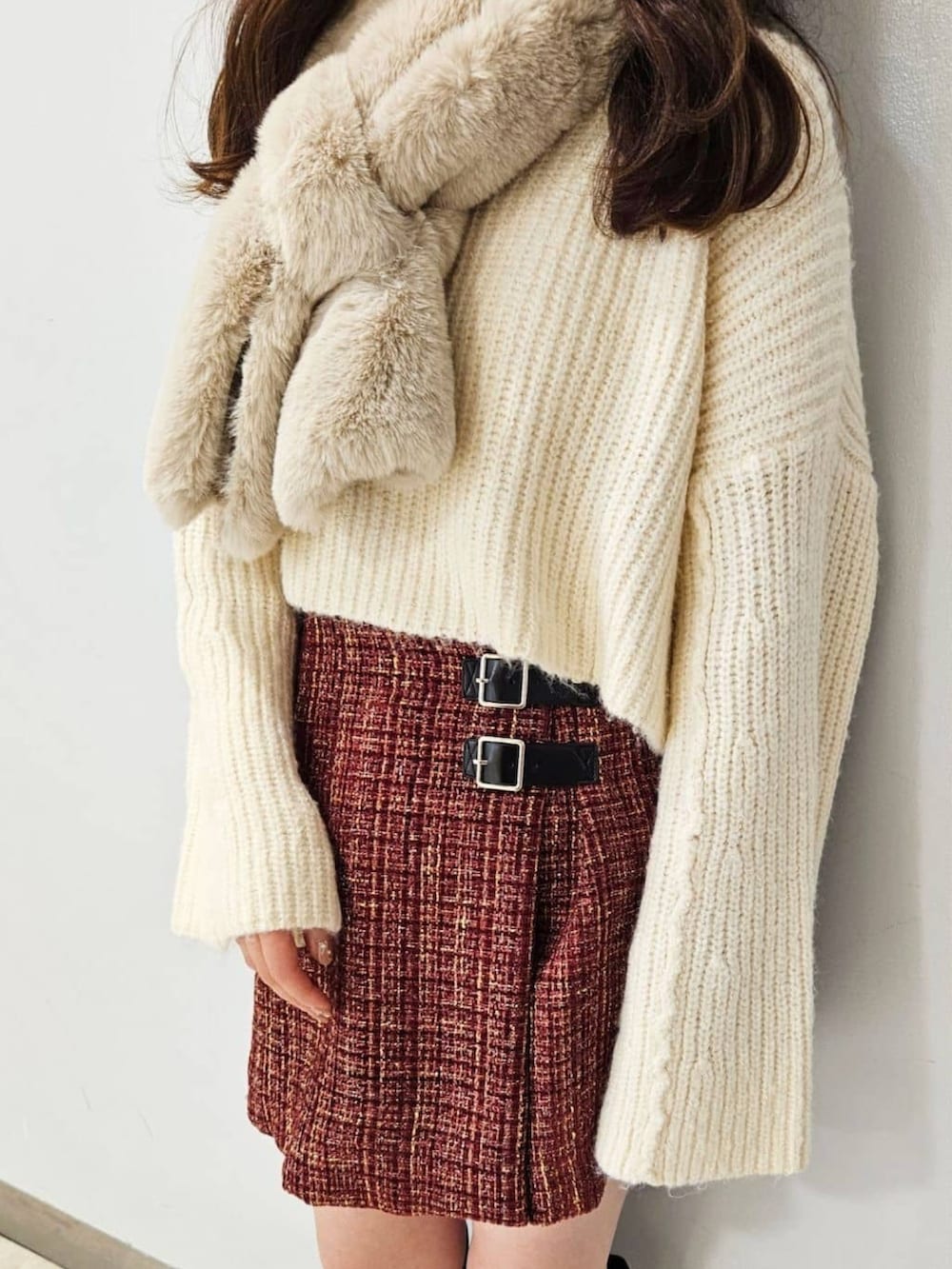 ホワイト系のニット/セーター、レッド系のスカート、ブラック系のショルダーバッグを着用したレディースの冬コーディネートの3枚目の写真