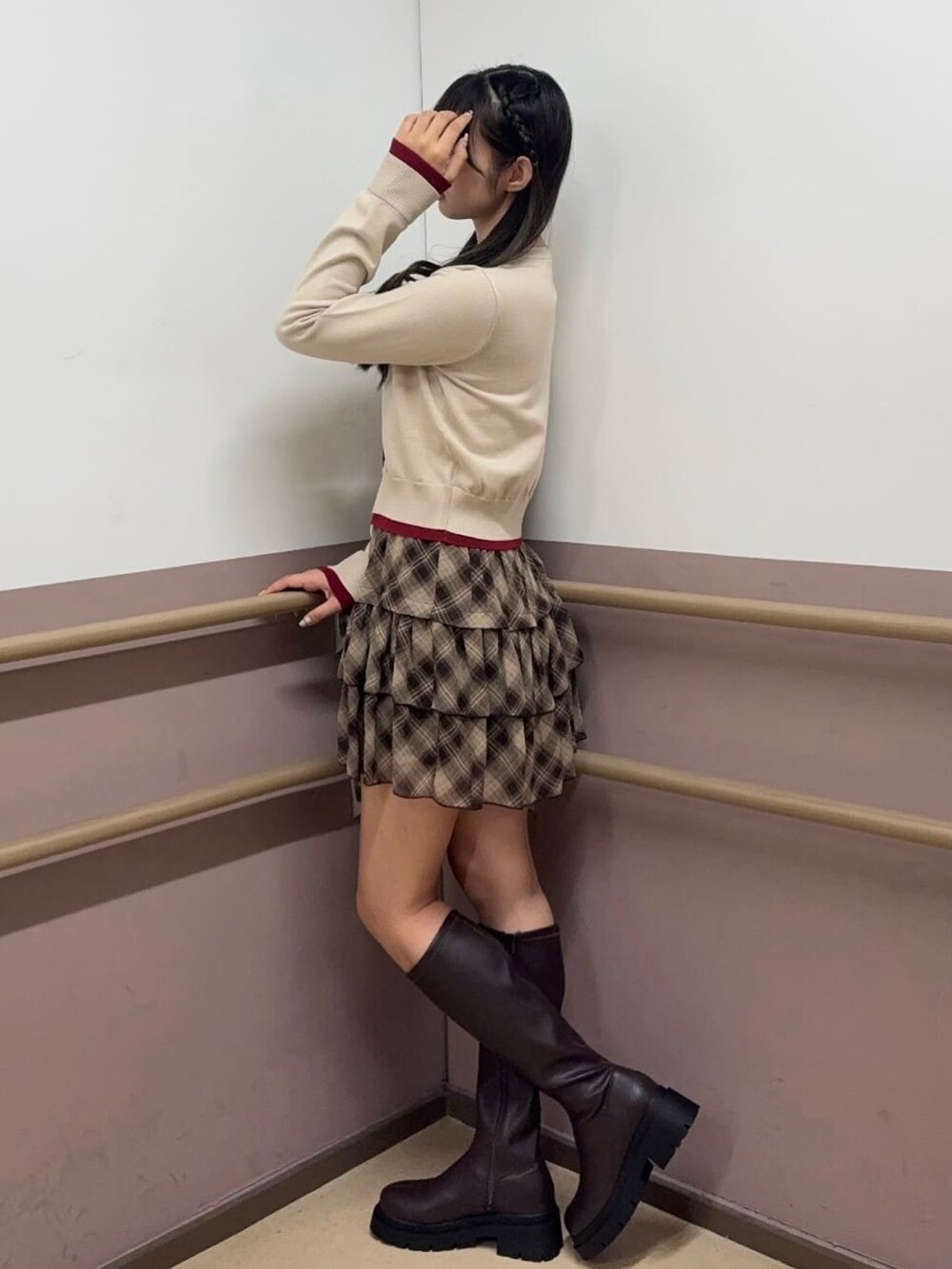 ホワイト系のカーディガン/ボレロ、ブラウン系のスカート、ブラウン系のブーツを着用したレディースの秋コーディネートの2枚目の写真