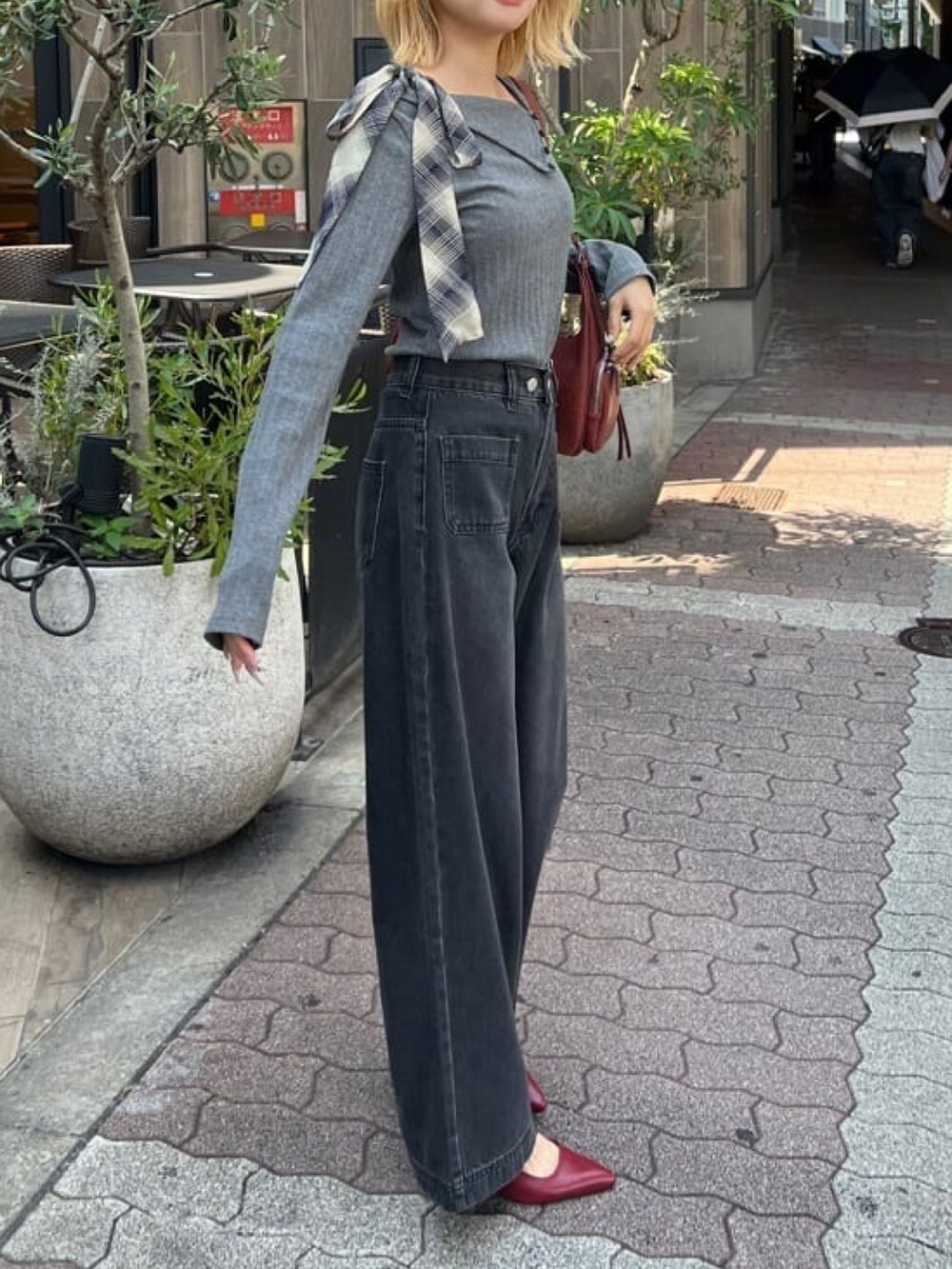 グレー系のTシャツ/カットソー、ホワイト系のデニムパンツ、レッド系のパンプスを着用したレディースの秋コーディネートの2枚目の写真