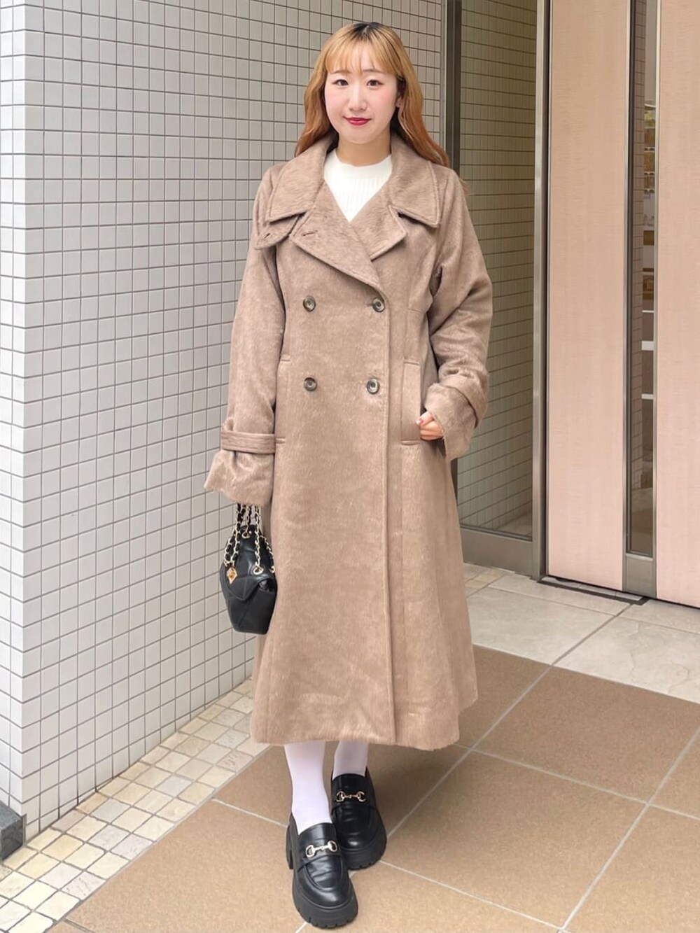 ブラウン系のその他アウター、ブラック系のショルダーバッグ、グレー系のローファーを着用したレディースの冬コーディネートの2枚目の写真