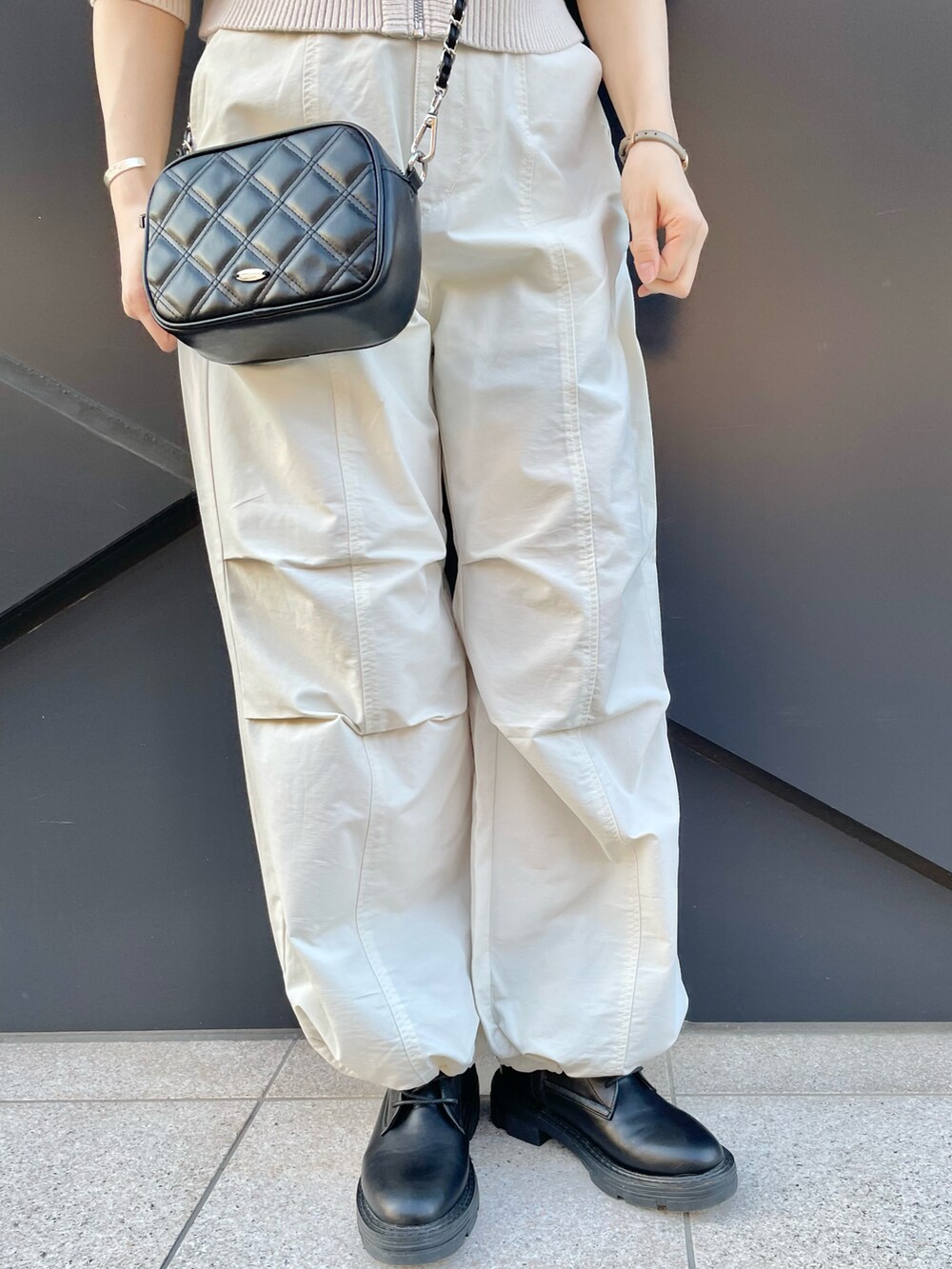 ホワイト系のカーディガン/ボレロ、ホワイト系のカーゴパンツ、ブラック系のショルダーバッグを着用したレディースの冬コーディネートの4枚目の写真