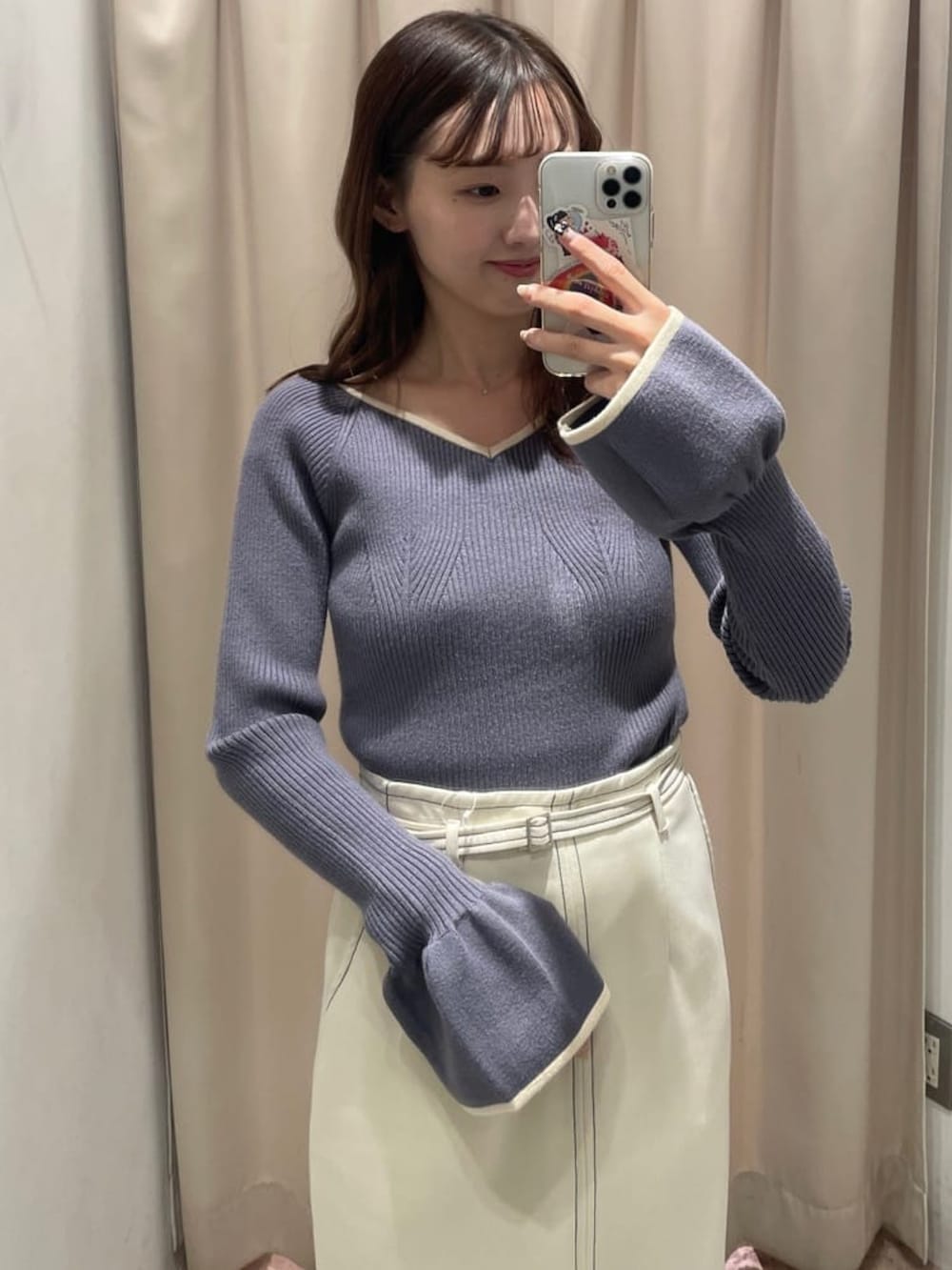 ブルー系のニット/セーター、ホワイト系のスカート、ブラック系のローファーを着用したレディースの冬コーディネートの2枚目の写真