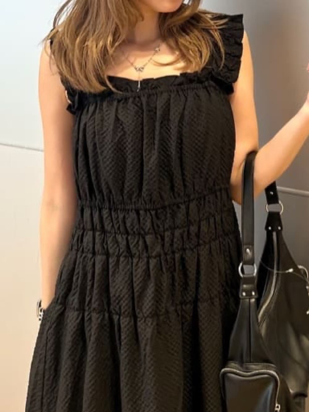 ブラック系のワンピース、グレー系のサンダル、ブラック系のショルダーバッグを着用したレディースの夏コーディネートの3枚目の写真