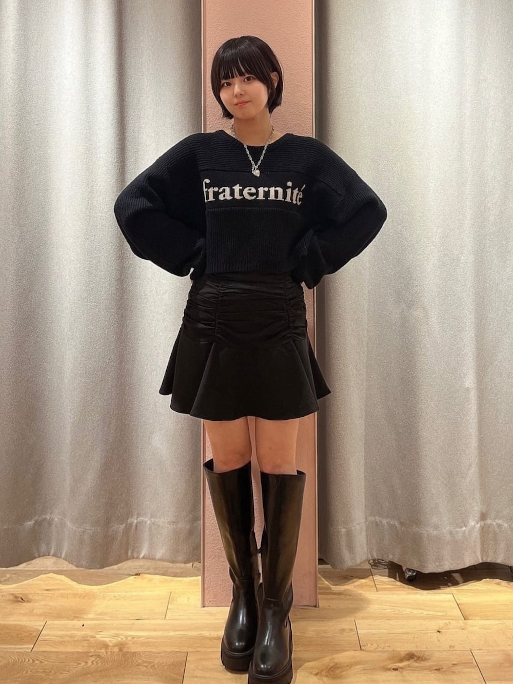 ホワイト系のブルゾン、ホワイト系のニット/セーター、ブラック系のスカートを着用したレディースの冬コーディネートの3枚目の写真