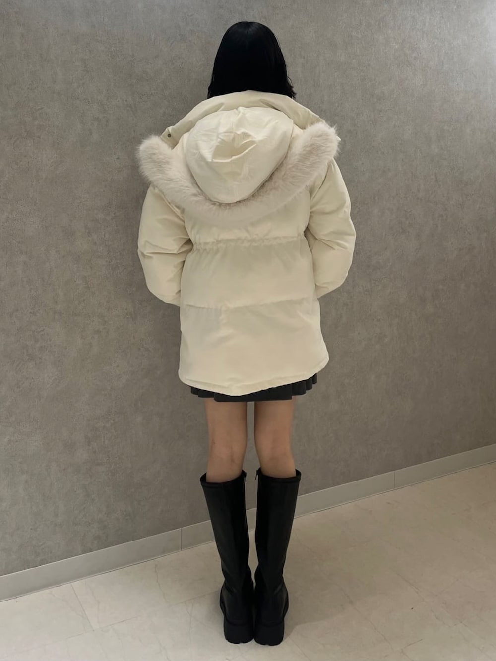 ブラック系のブルゾン、ホワイト系のニット/セーターを着用したレディースの冬コーディネートの3枚目の写真