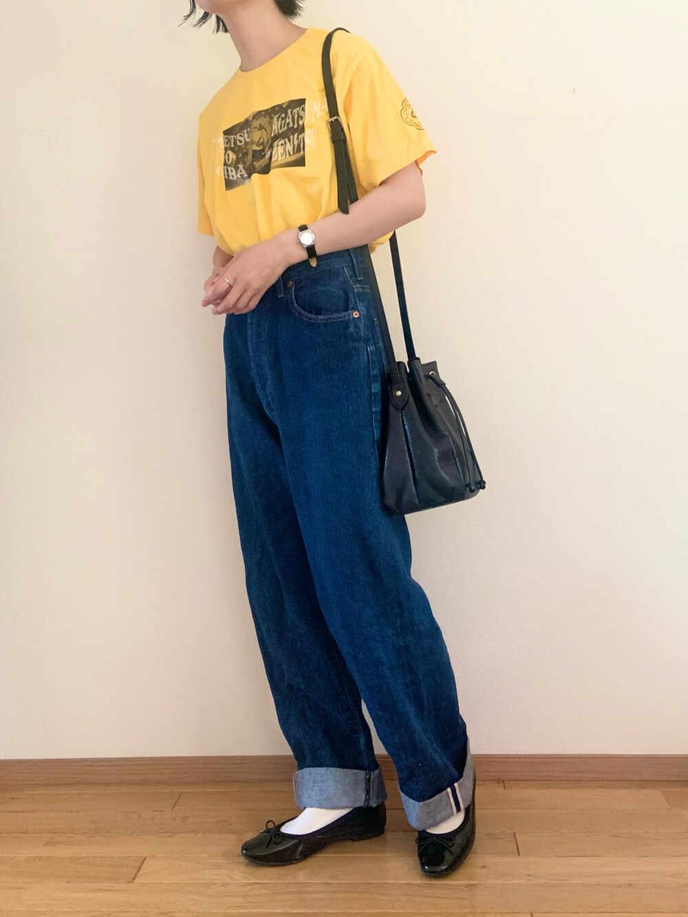 ブルー系のデニムパンツ、イエロー系のTシャツ/カットソー、ブラック系のパンプスを着用したレディースの夏コーディネートの2枚目の写真