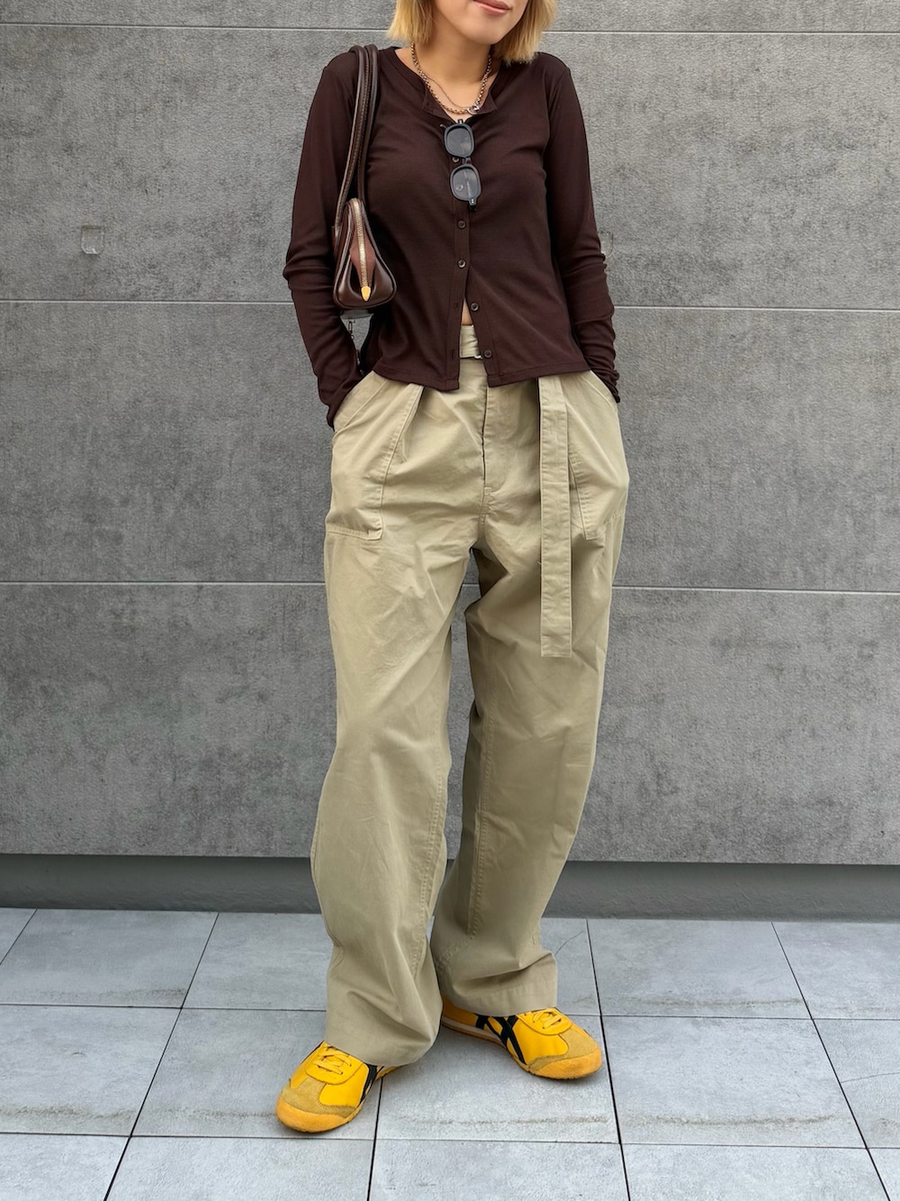 ベージュ系のその他パンツ、イエロー系のスニーカー、ブラウン系のカーディガン/ボレロを着用したレディースの春コーディネートの3枚目の写真