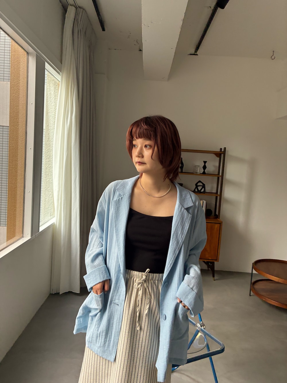 ブルー系のテーラードジャケット、ホワイト系のスカートを着用したレディースの夏コーディネートの5枚目の写真