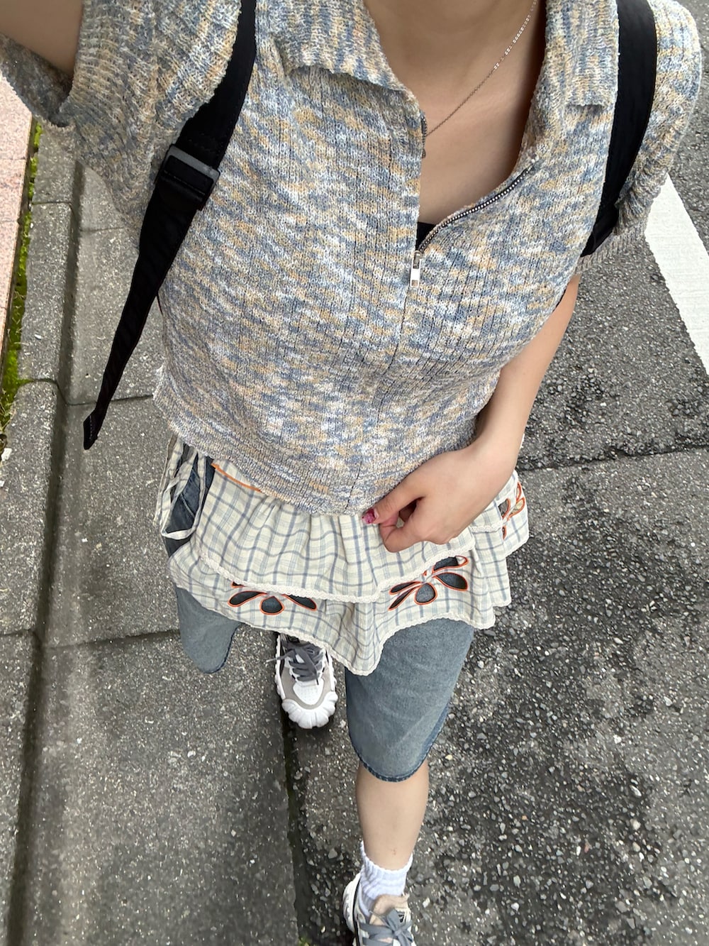 ベージュ系のスカート、グレー系のトップス、ブルー系のデニムパンツを着用したレディースの夏コーディネートの2枚目の写真