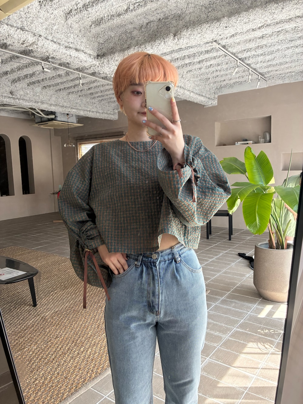 グリーン系のシャツ/ブラウス、ブルー系のデニムパンツを着用したレディースの春コーディネートの3枚目の写真