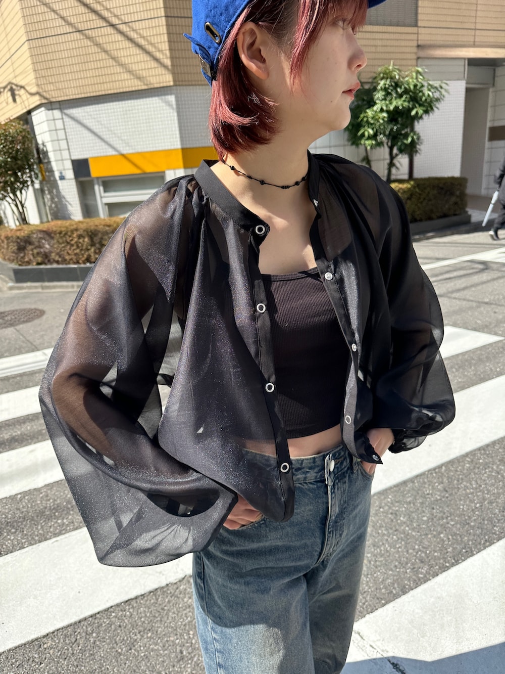 ブラック系のシャツ/ブラウス、ブルー系のキャップを着用したレディースの春コーディネートの3枚目の写真