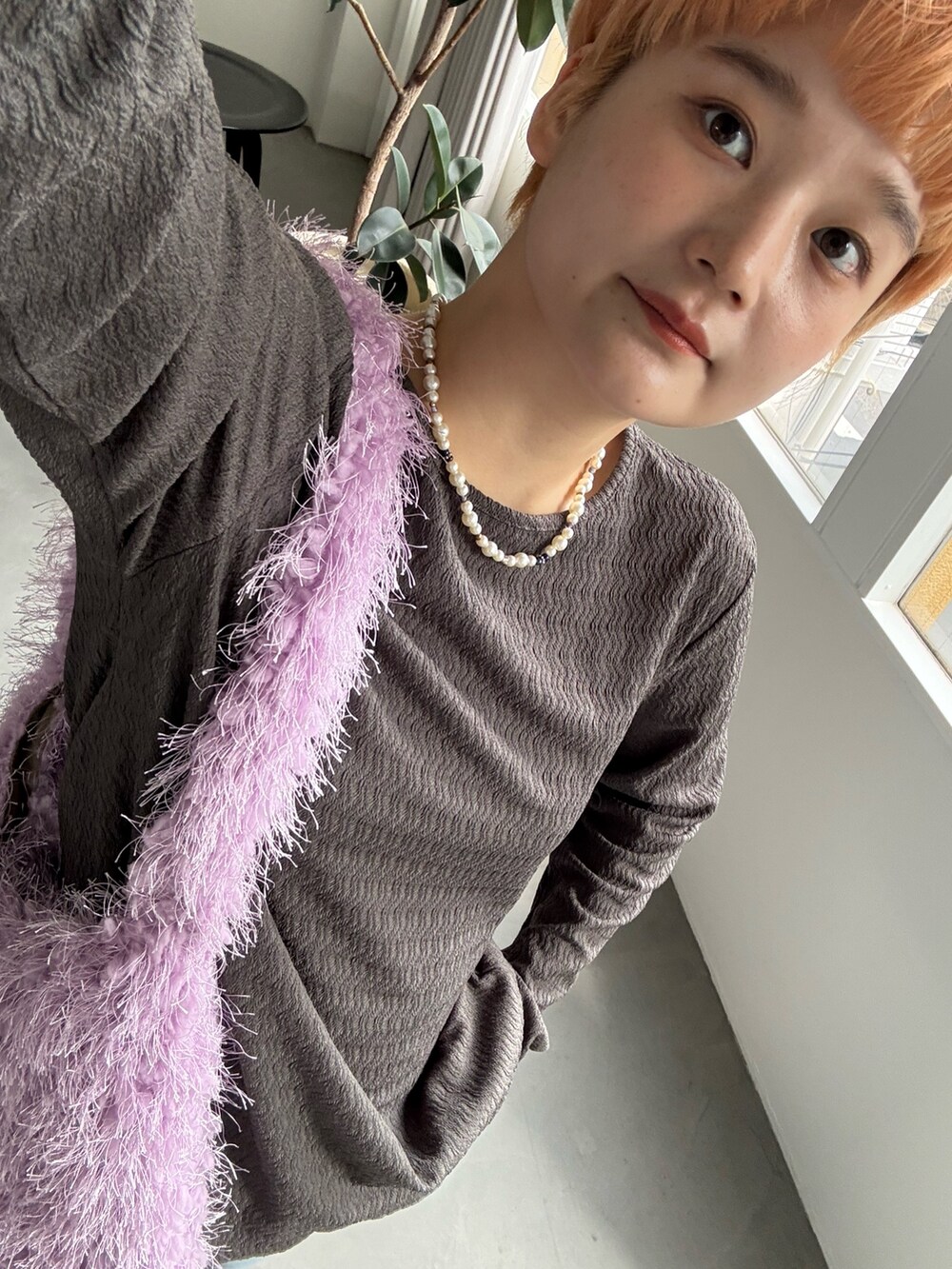 グレー系のカーディガン/ボレロ、パープル系のトートバッグ、ブルー系のデニムパンツを着用したレディースの秋コーディネートの5枚目の写真