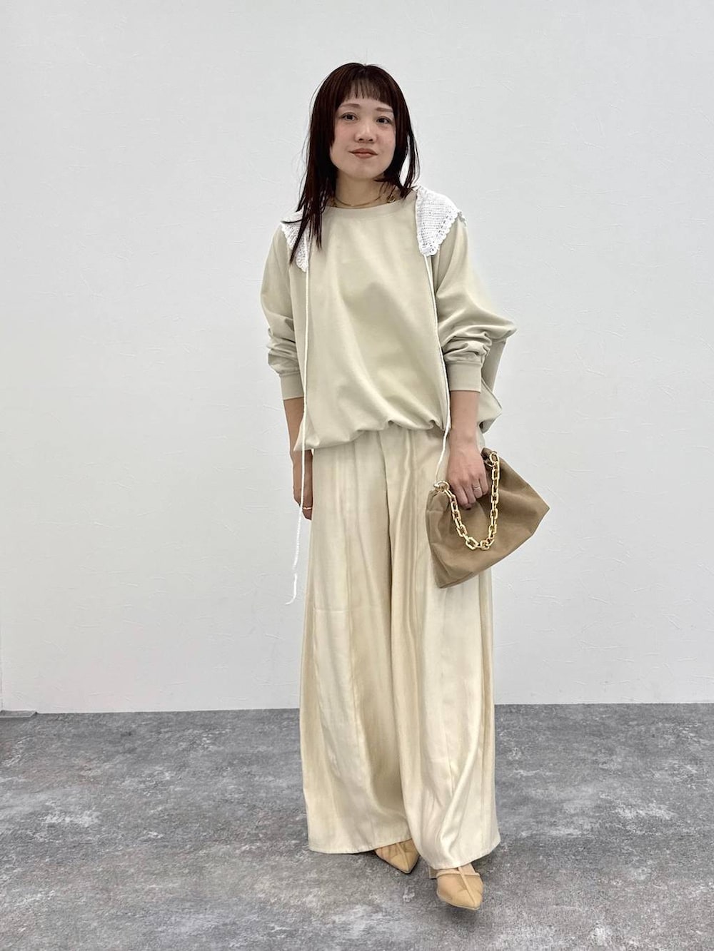 ホワイト系のその他パンツ、ベージュ系のショルダーバッグ、ホワイト系のストール/ショールを着用したレディースの春コーディネートの4枚目の写真