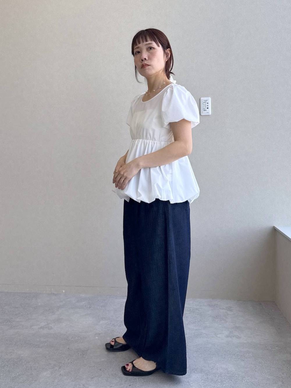 ブルー系のデニムパンツ、ブラック系のパンプス、ホワイト系のシャツ/ブラウスを着用したレディースの春コーディネートの6枚目の写真