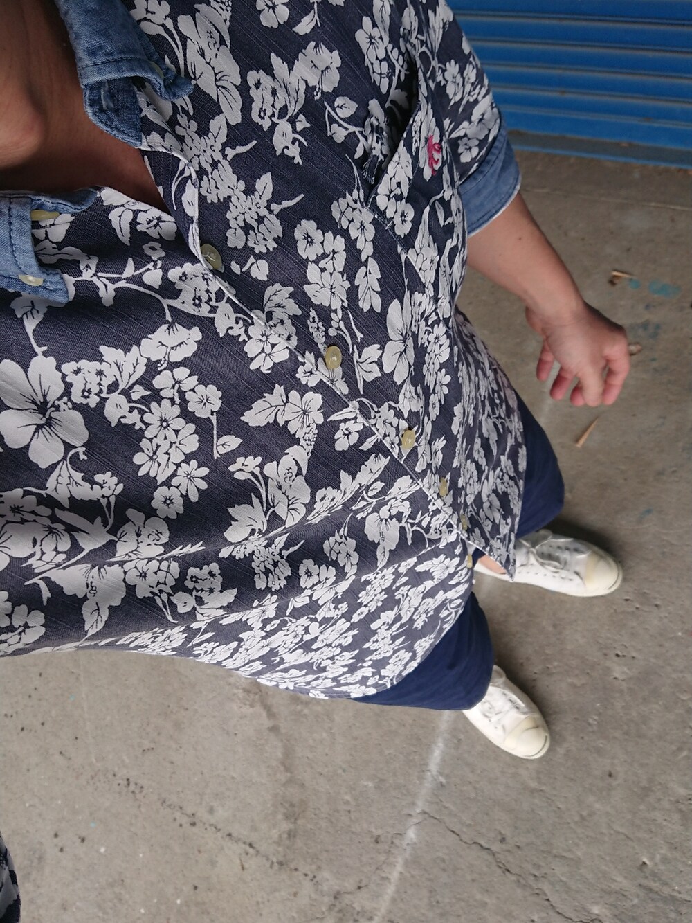 ホワイト系のスニーカー、ブルー系のチノパンツ、ブルー系のシャツ/ブラウスを着用したメンズの夏コーディネートの2枚目の写真