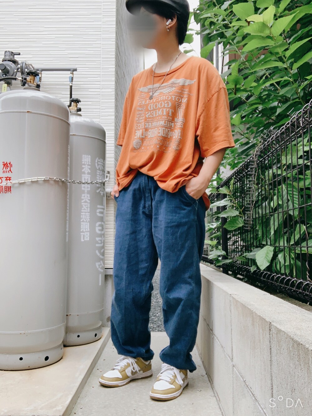 オレンジ系のTシャツ/カットソー、ブルー系のデニムパンツ、イエロー系のスニーカーを着用したレディースの夏コーディネートの2枚目の写真