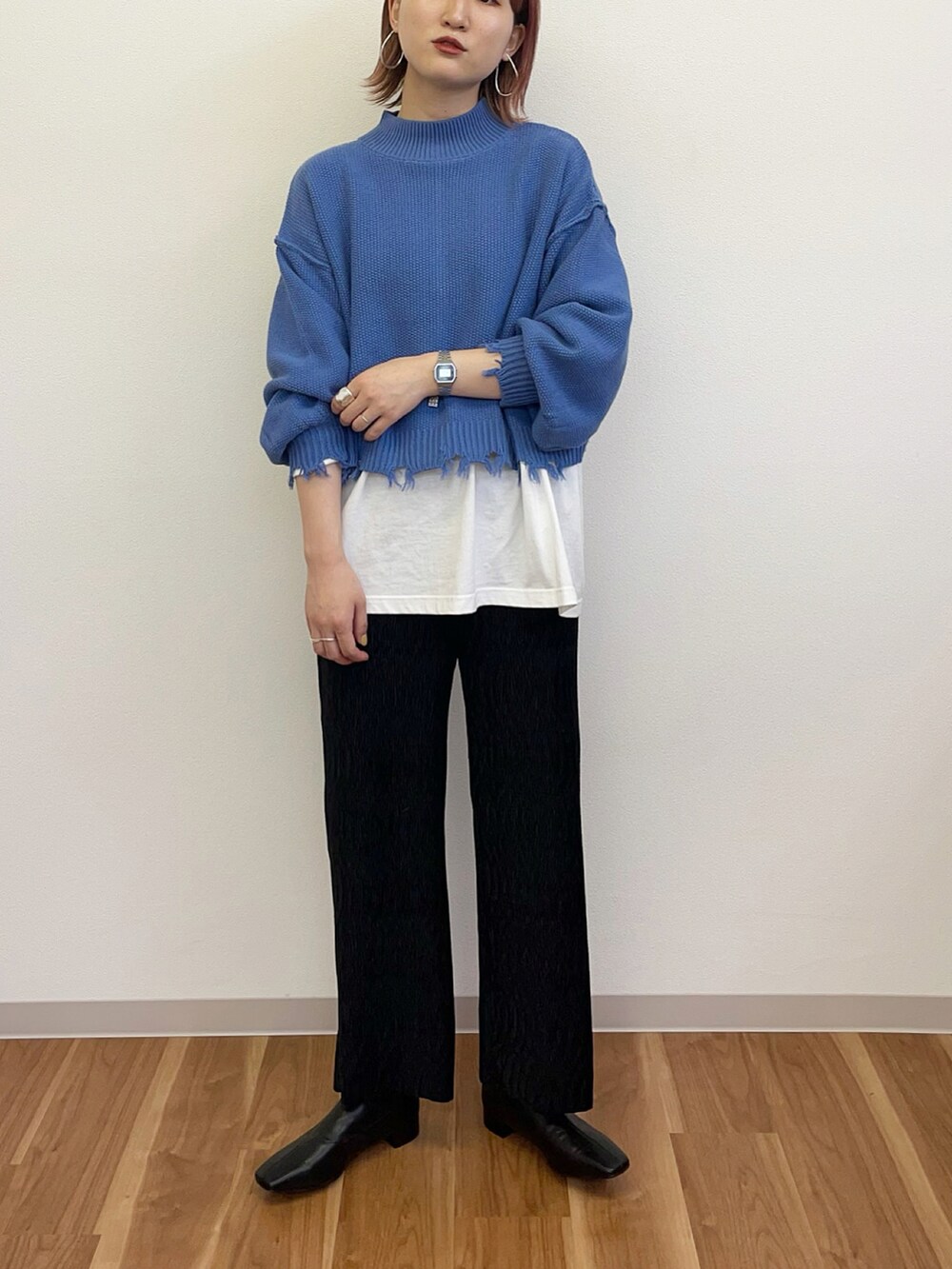 ブルー系のニット/セーター、ブラック系のその他パンツ、ブラック系のブーツを着用したレディースの冬コーディネートの2枚目の写真