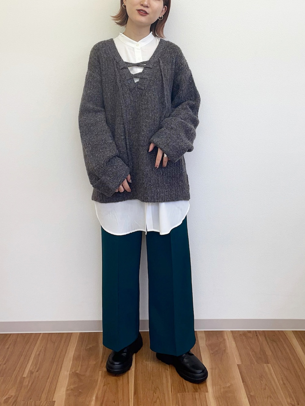 グリーン系のその他パンツ、ブラック系のその他シューズ、グレー系のニット/セーターを着用したレディースの冬コーディネートの3枚目の写真